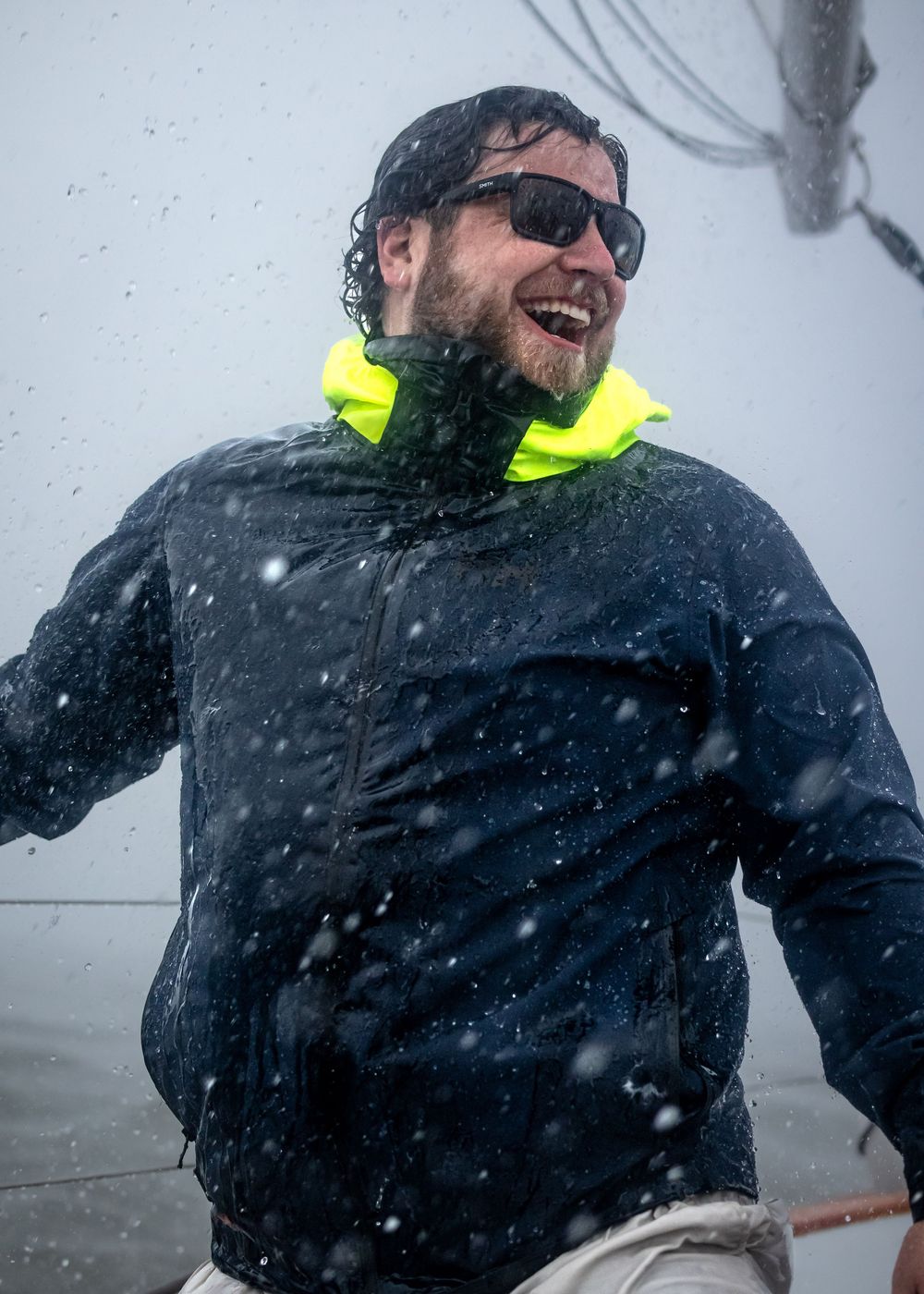 Sailor enjoying a surprise thunderstorm on the chesapeake bay for brand photoshoot.
