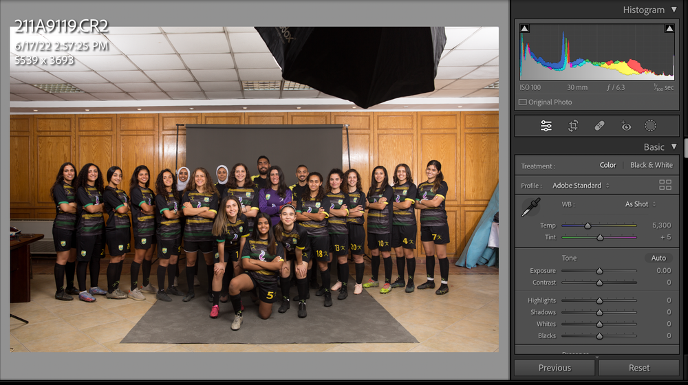 Group photo showing athletes in matching uniforms lined up in a studio setting.