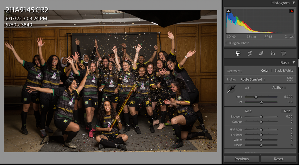 Team photo session in a studio with athletes in matching uniforms.