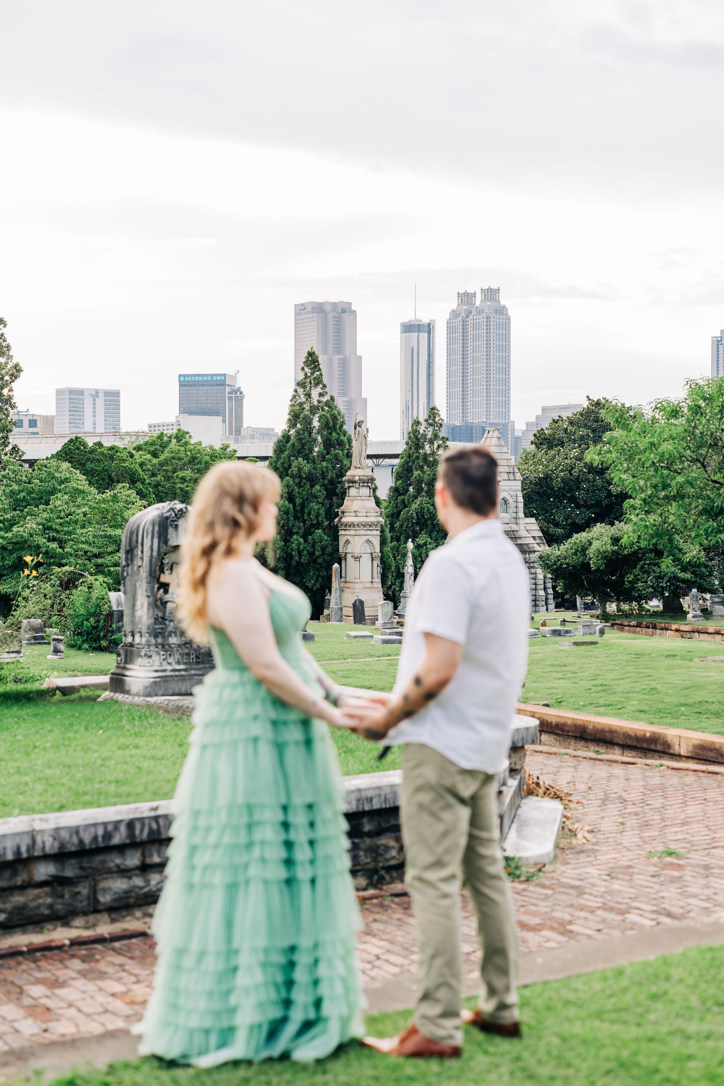Series of candid moments showing a couple in a mint green gown and casual attire dancing in an urban park setting.