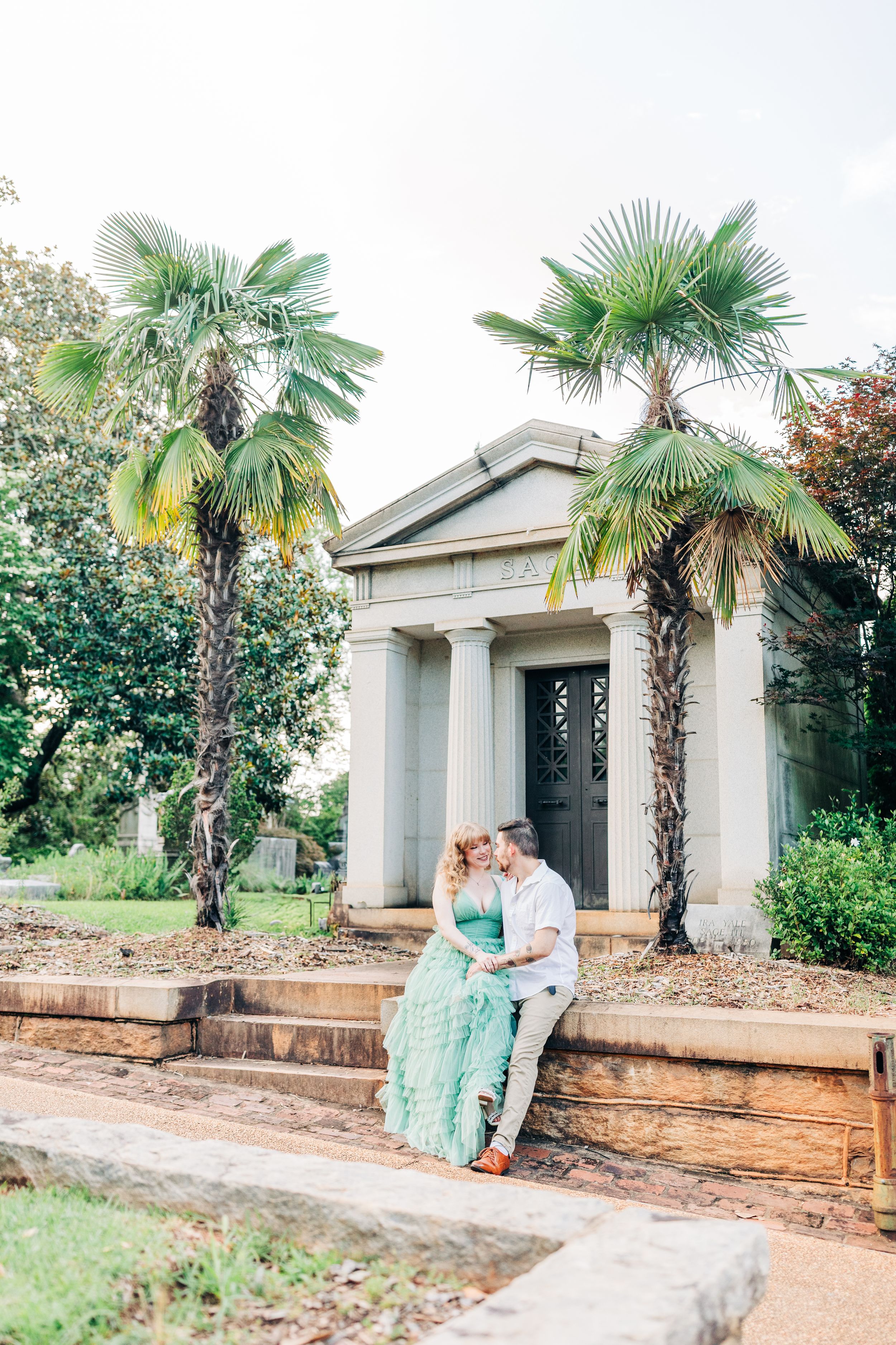 Sequence of engagement photos at a stone pavilion with palm trees and landscaping in a garden setting.