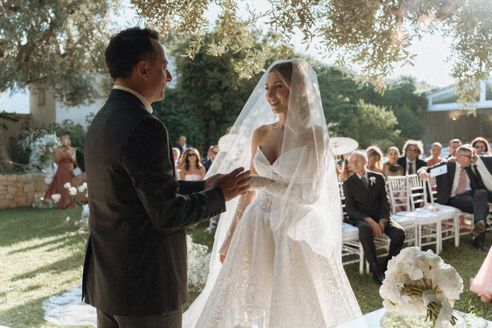 A romantic outdoor wedding ceremony with guests viewing bride and groom sharing intimate moments through multiple photos.