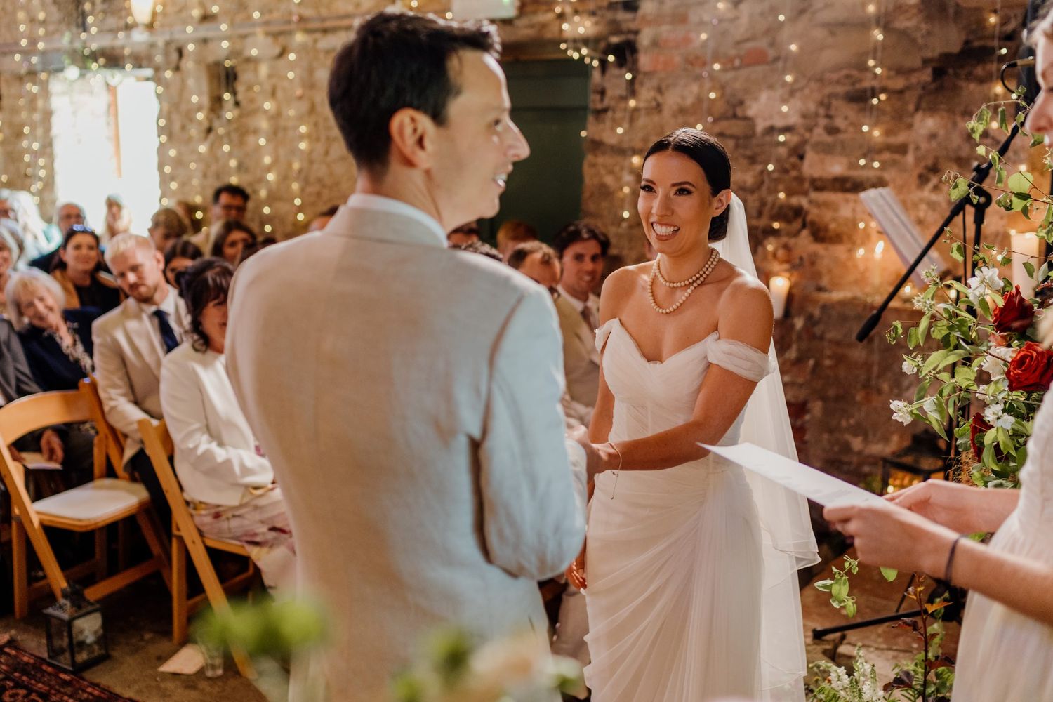 Wedding celebration in a rustic brick venue with couples dancing and twirling on the dance floor.