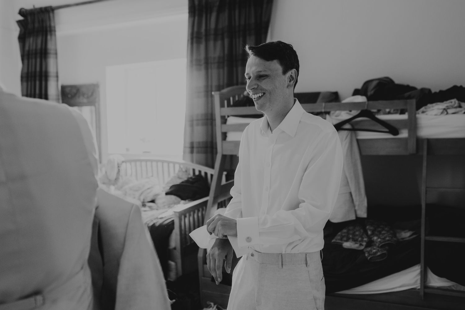 Black and white photo sequence showing wedding dress fitting and final adjustments.