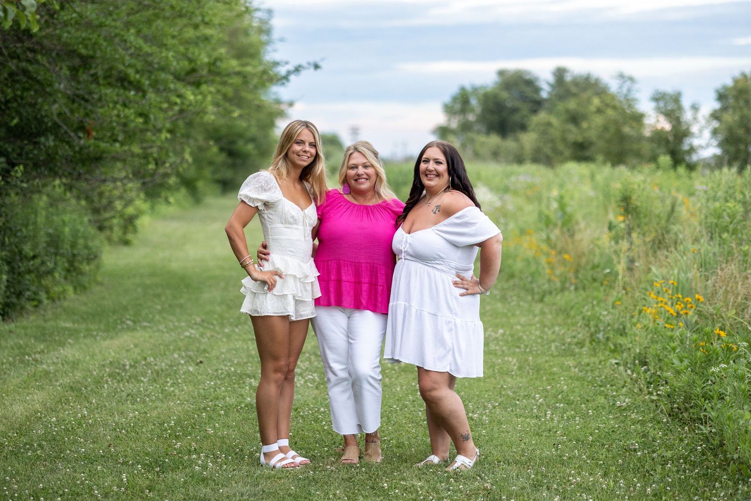 Springfield IL Photographer captures a mom and daughters together in a clearing near wildflowers at Centennial Park in Central IL