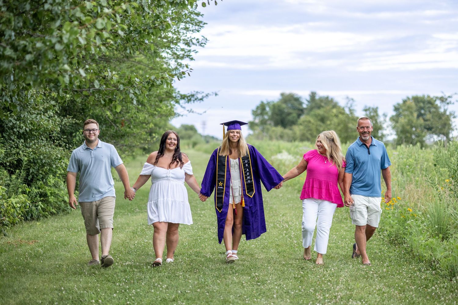 Springfield IL photographer captures a family walking together during a photo session at Centennial Park in Central IL