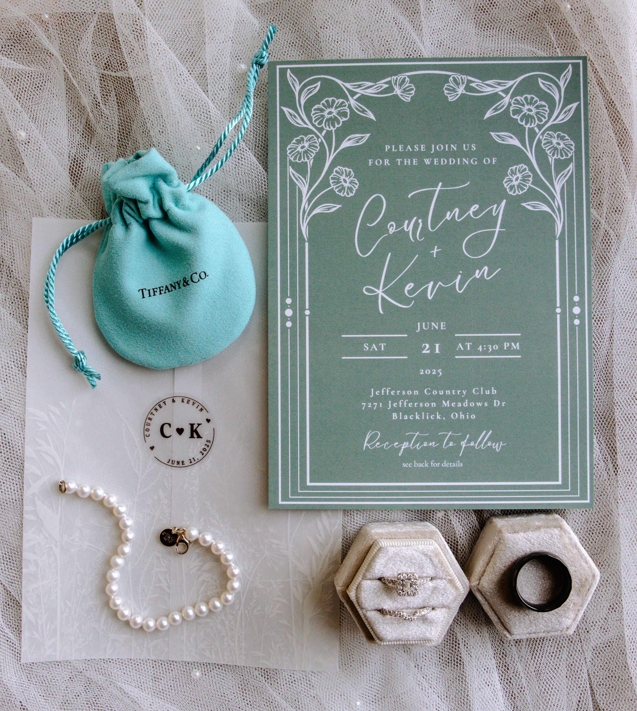 Wedding invitation suite in sage green with Tiffany blue jewelry pouches and pearl accessories.
