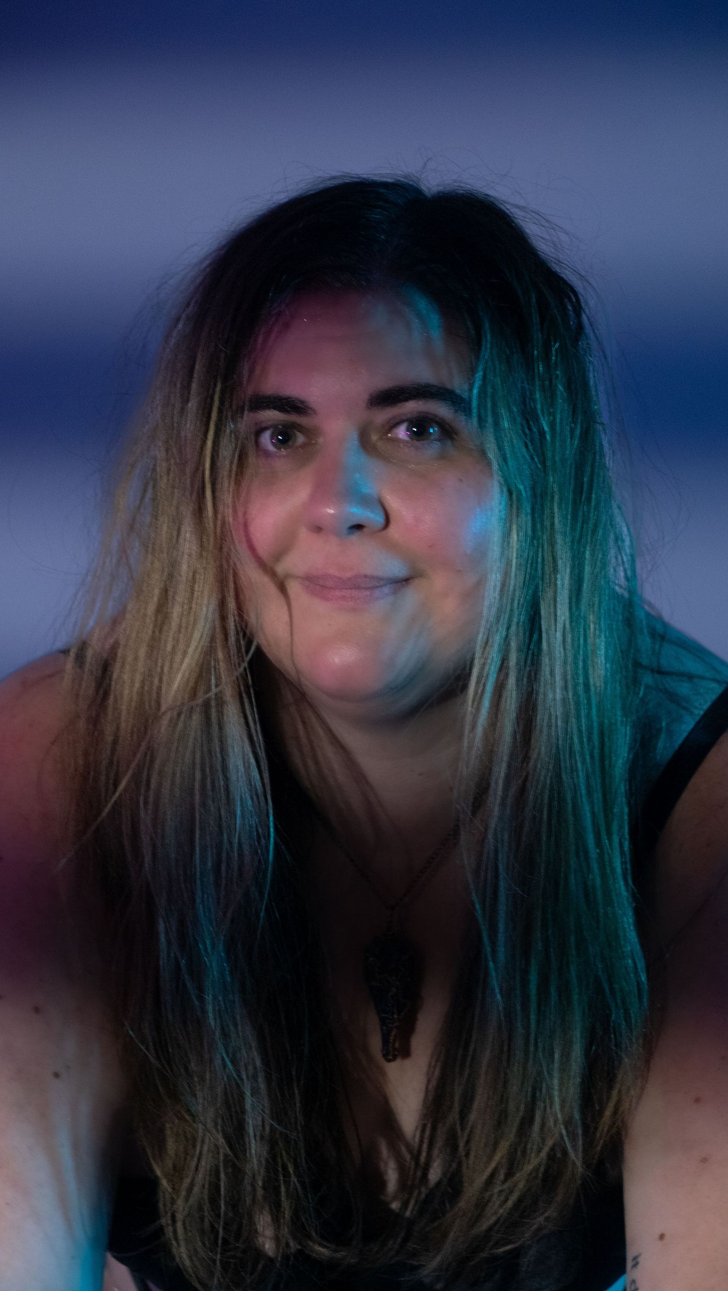 A sequence shows someone's hair transforming from dark to bright turquoise blue in dramatic lighting.