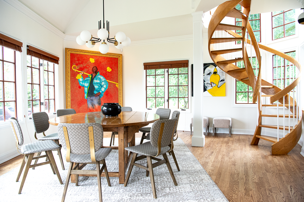 spiral staircase in dining room with large scale artwork