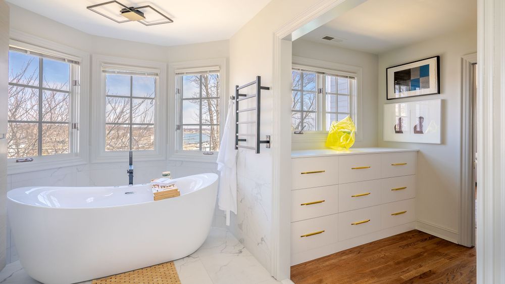 master bathroom with attached walk in closet, water view