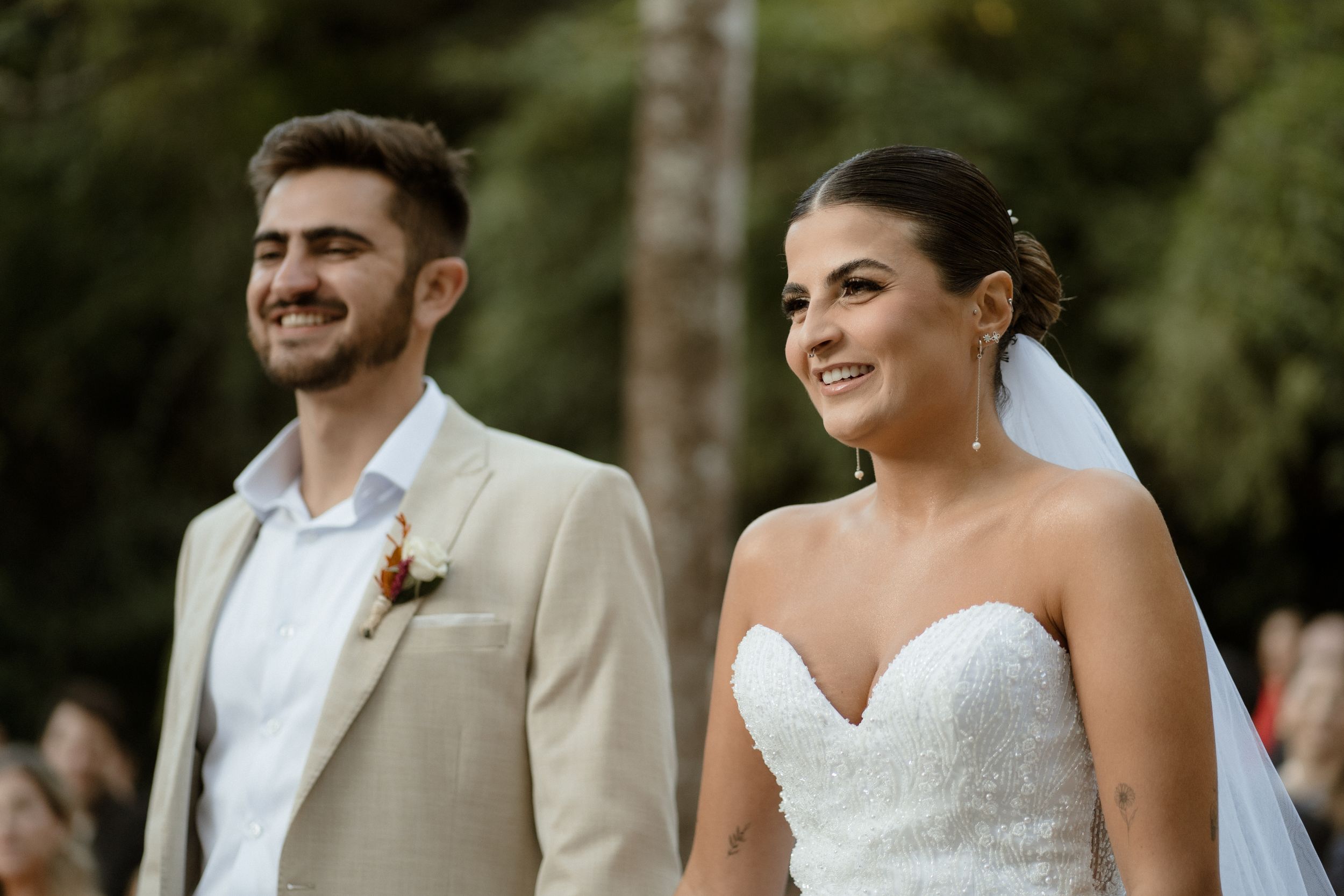 Couples share a lighthearted moment during their outdoor wedding ceremony.