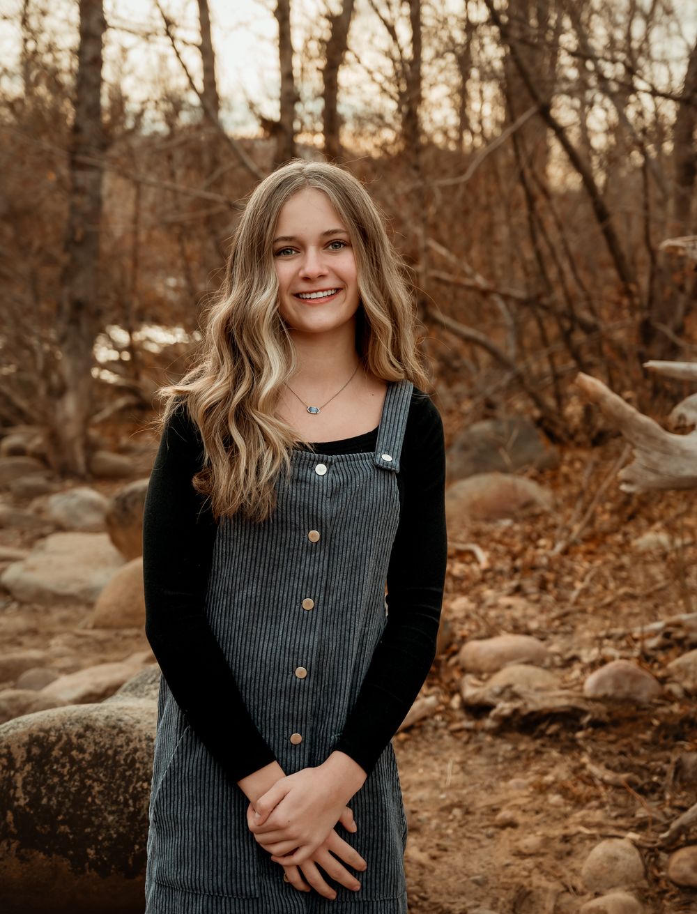 Portrait series in grey button-up dress against autumn riverside scenery.