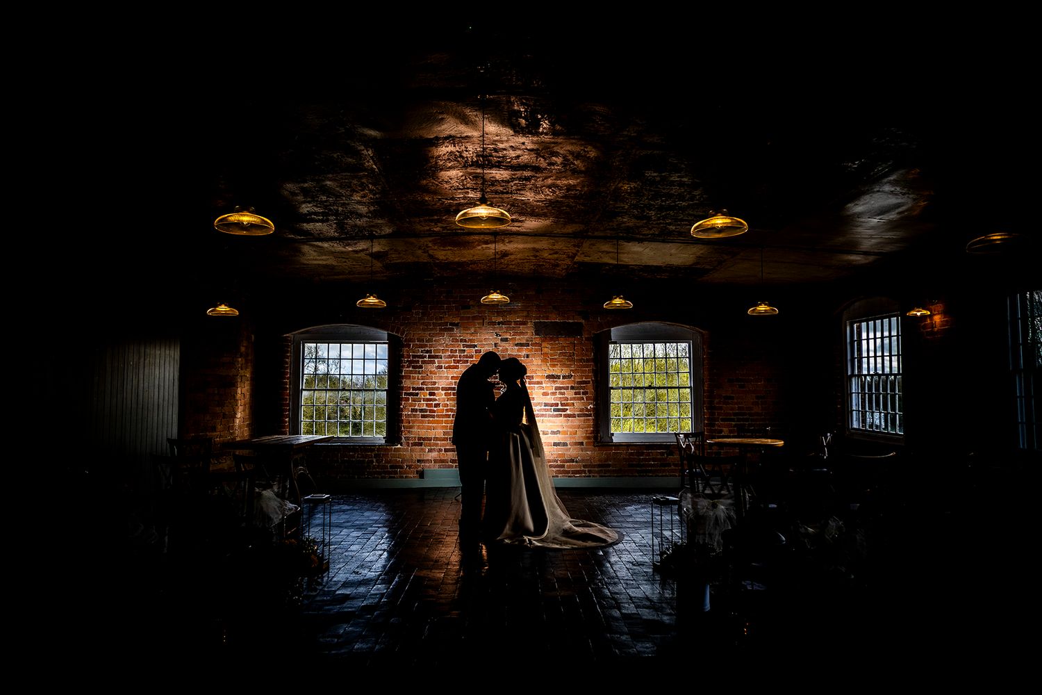 Silhouette of bride and groom at the West Mill Derby