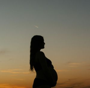 Dreamy sunset silhouette maternity session at Lake Arrowhead TX, earthy soulful portrait.