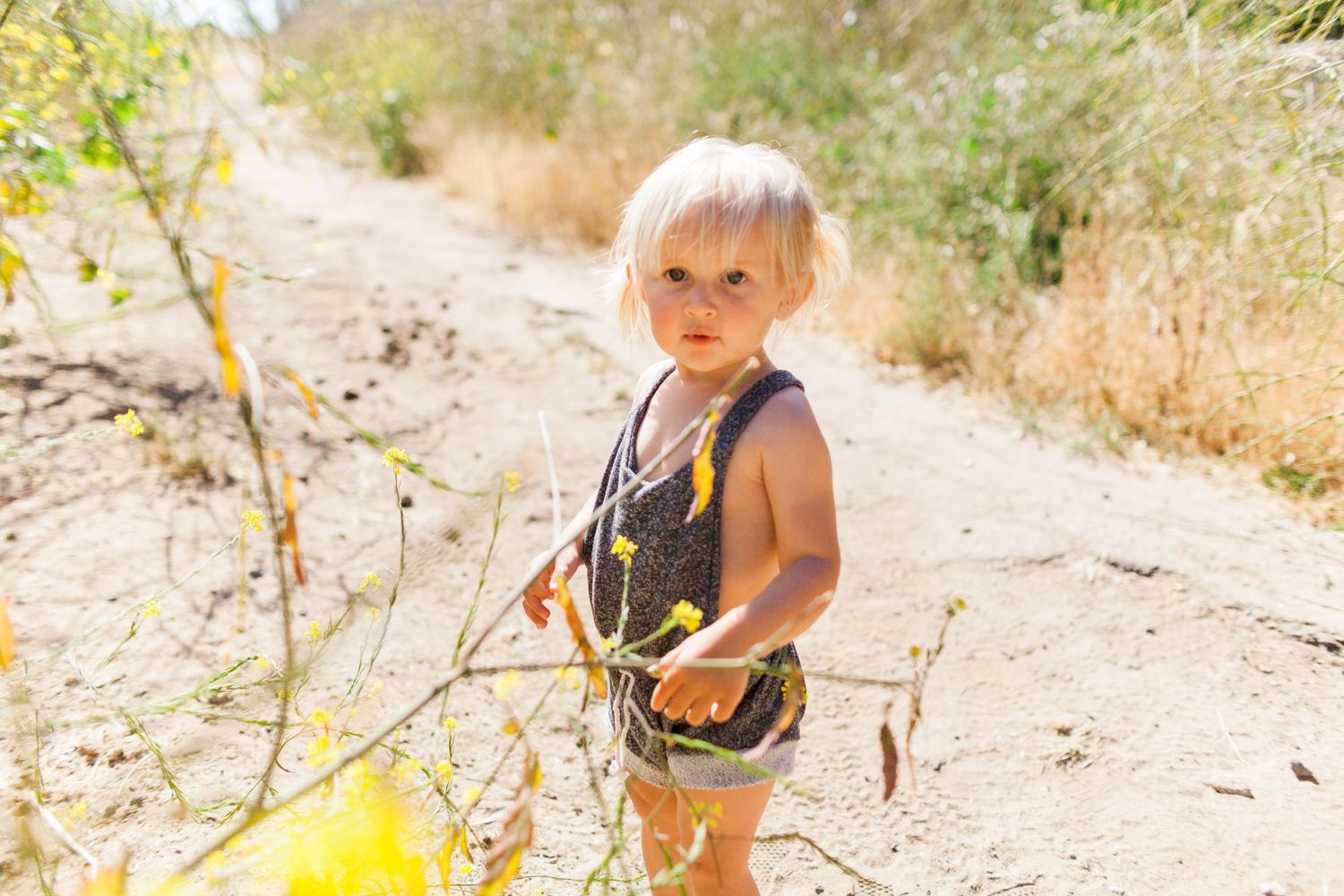 toddler wearing a romper in nature