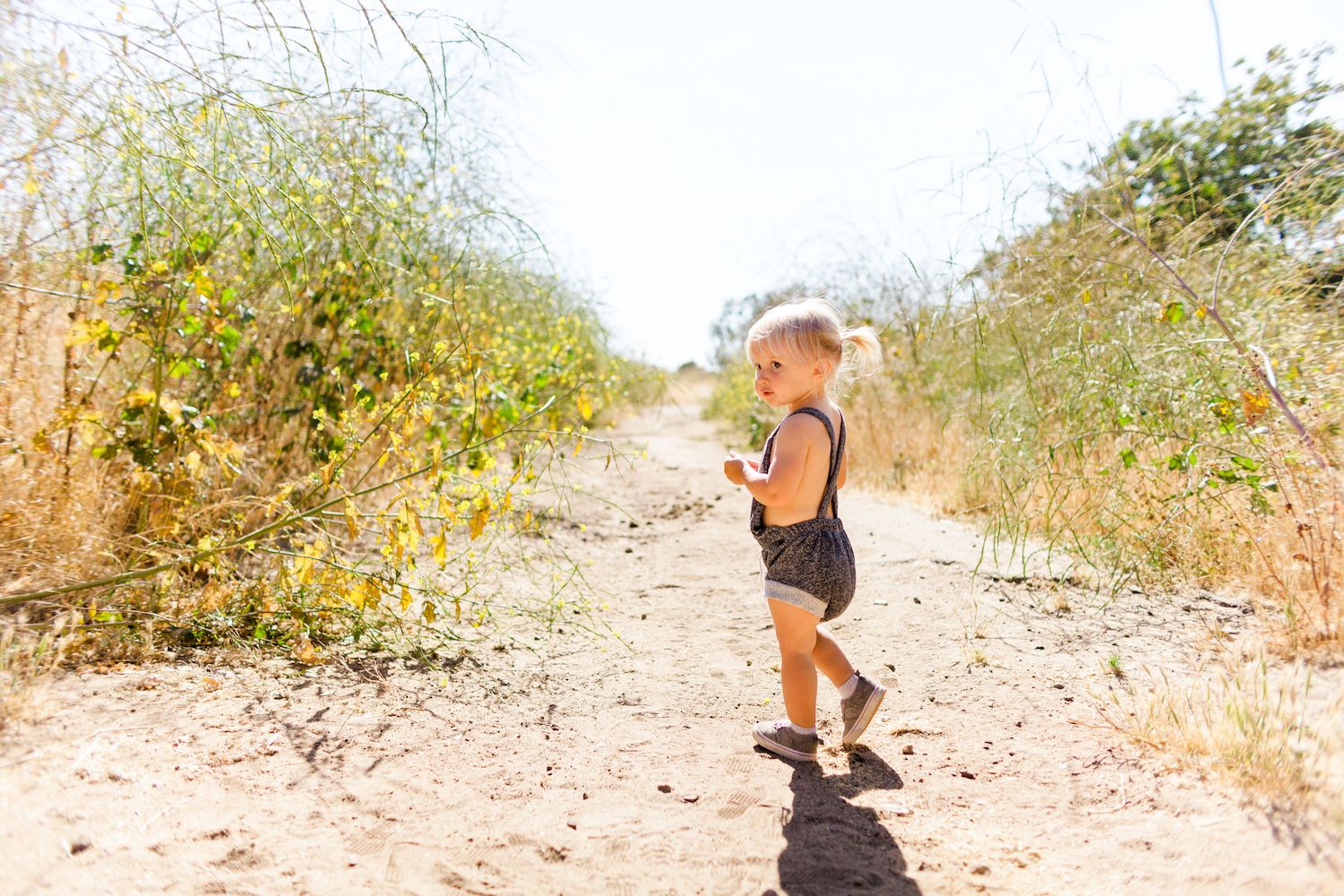 toddler wearing a romper in nature