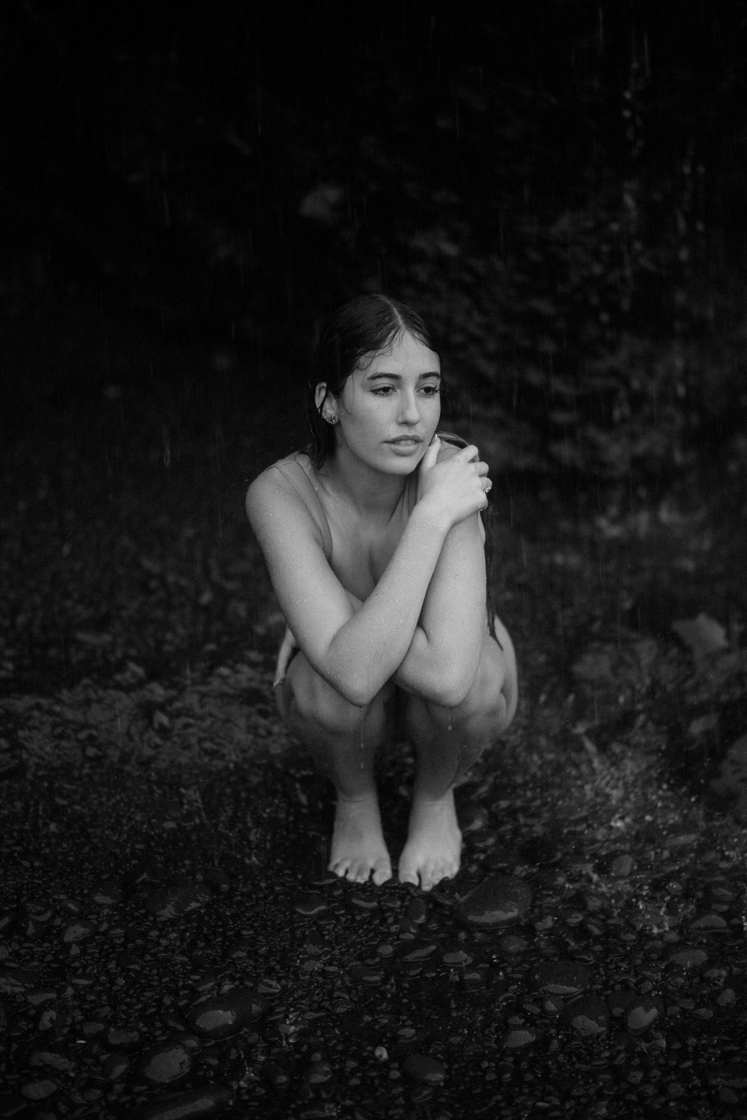 A black and white artistic photo sequence showing a crouched figure against a dark background.
