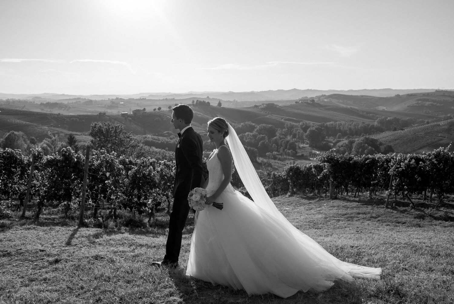 Wedding couple walking through vineyards at La Villa Hotel Mombaruzzo in Piedmont