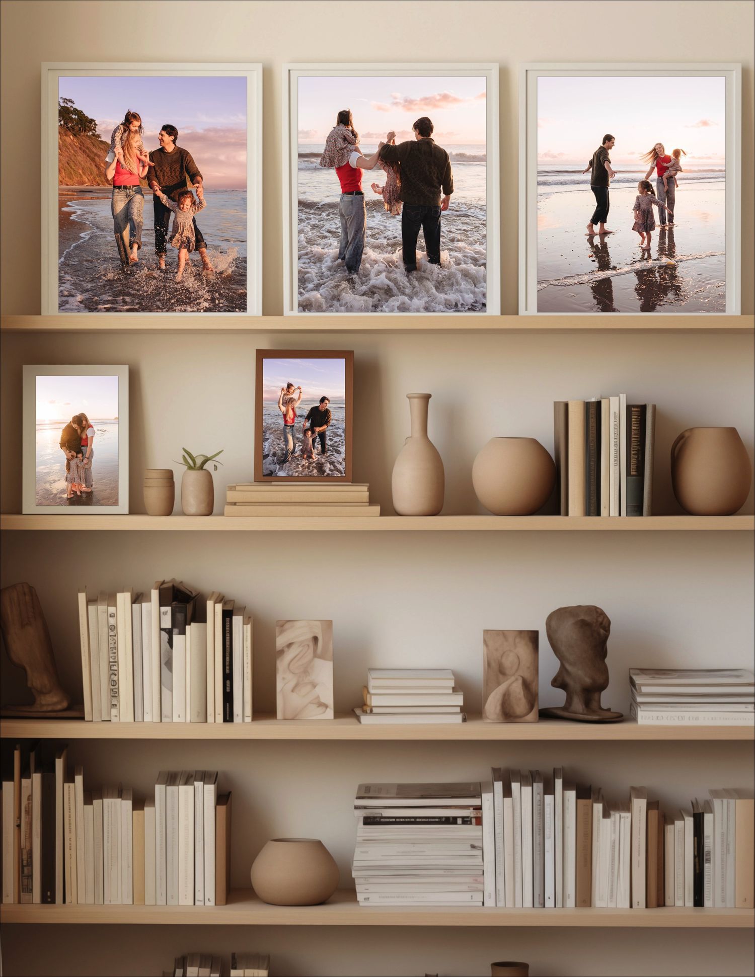 A collection of framed photographs displayed on white shelves with pottery and books creating a modern gallery wall.