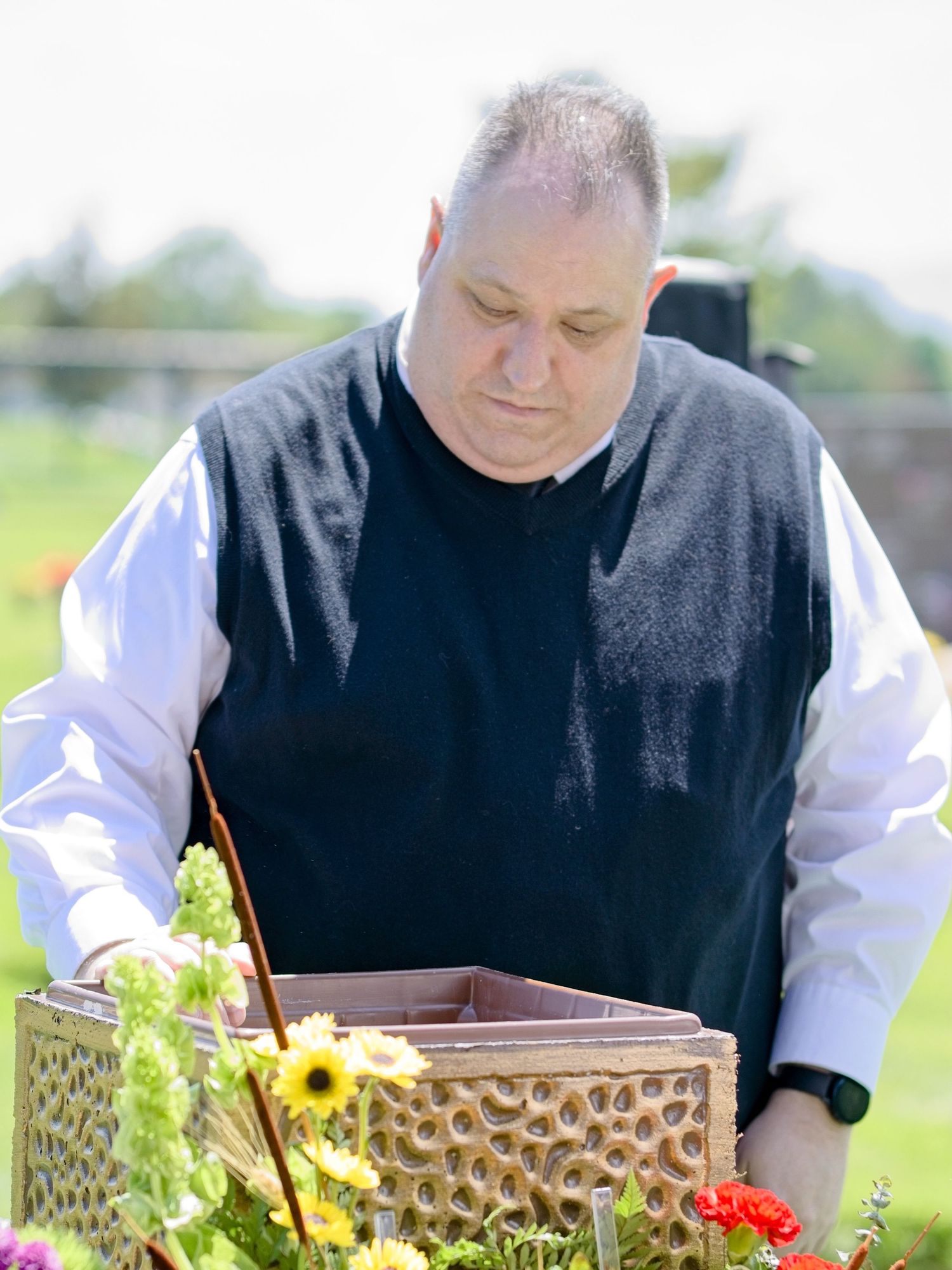 A man places sentimental possessions into the vault for his brother's ashes