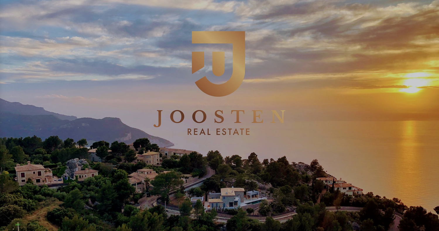 Luxurious coastal villas and properties overlooking a golden sunset on the Mediterranean coastline.