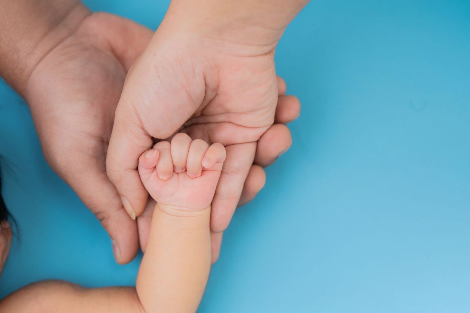 Newborn baby's tiny hand held by both parents - best newborn photographer in Hyderabad, Bump To Baby by Sai Jyothi