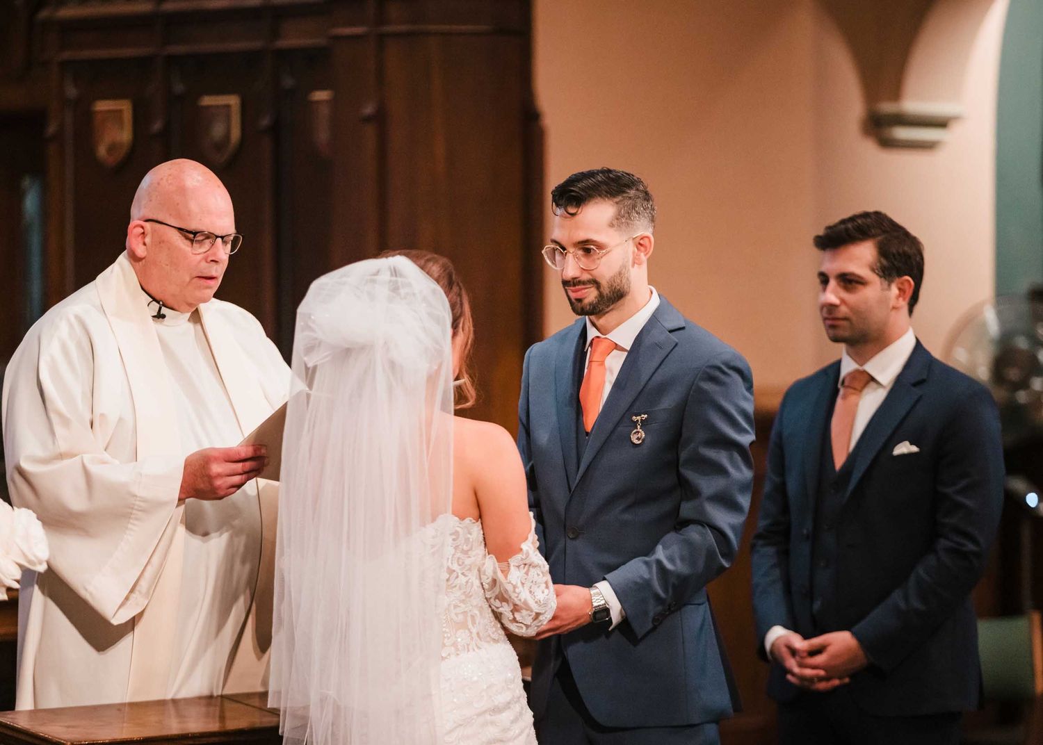 Bride and groom exchanging vows during a Catholic wedding ceremony at Saint Brigid Church in South Boston