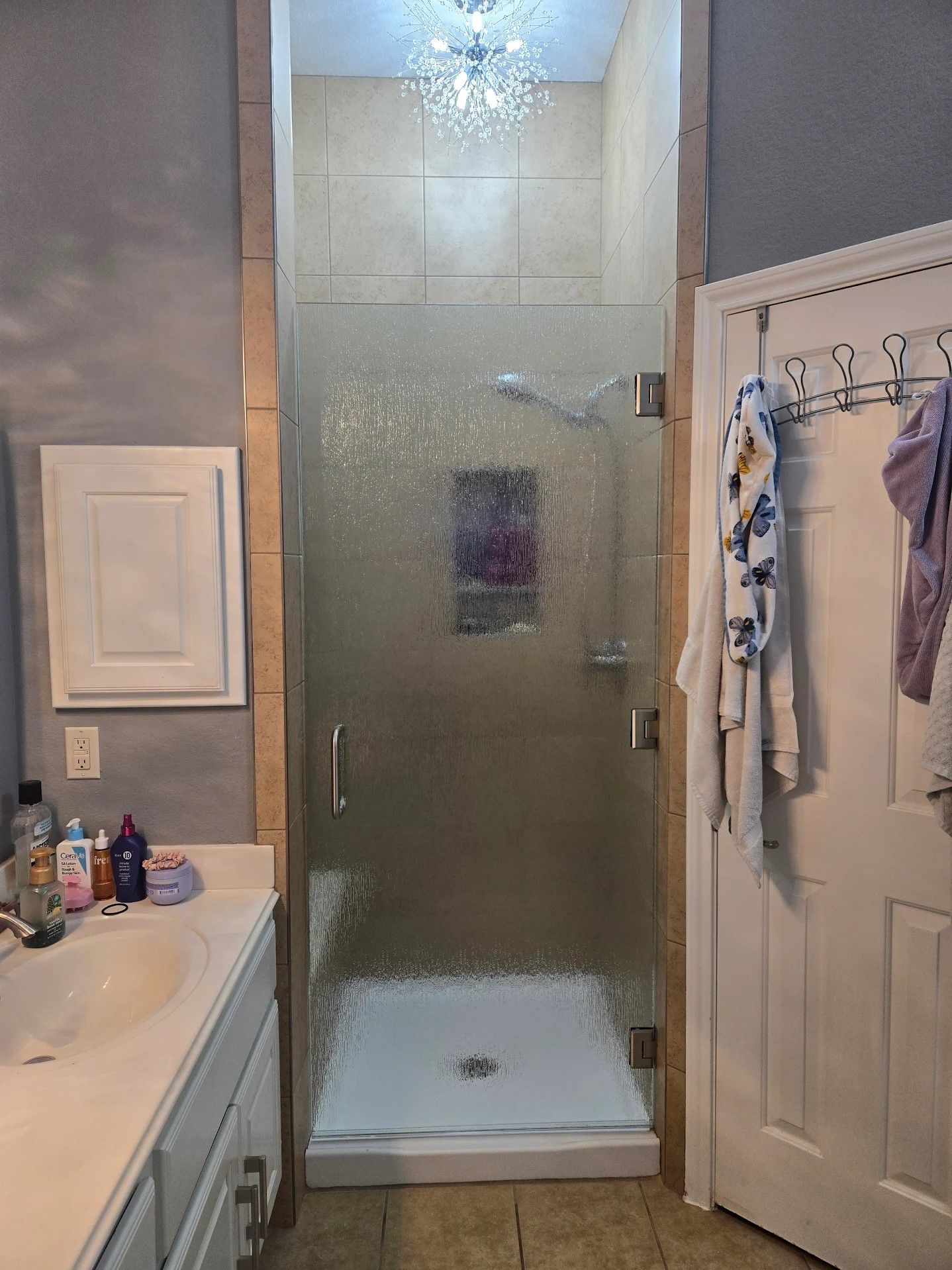 A bathroom renovation progress shown in five sequential photos displaying wall and floor updates.