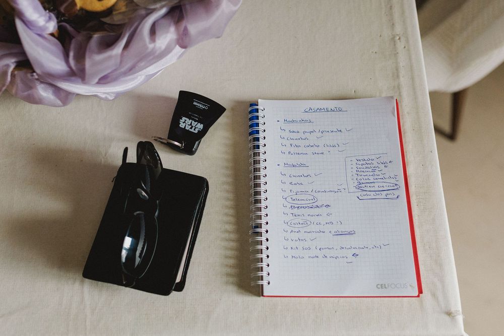 Wedding preparation checklist in a notebook during the bride's morning preparations.