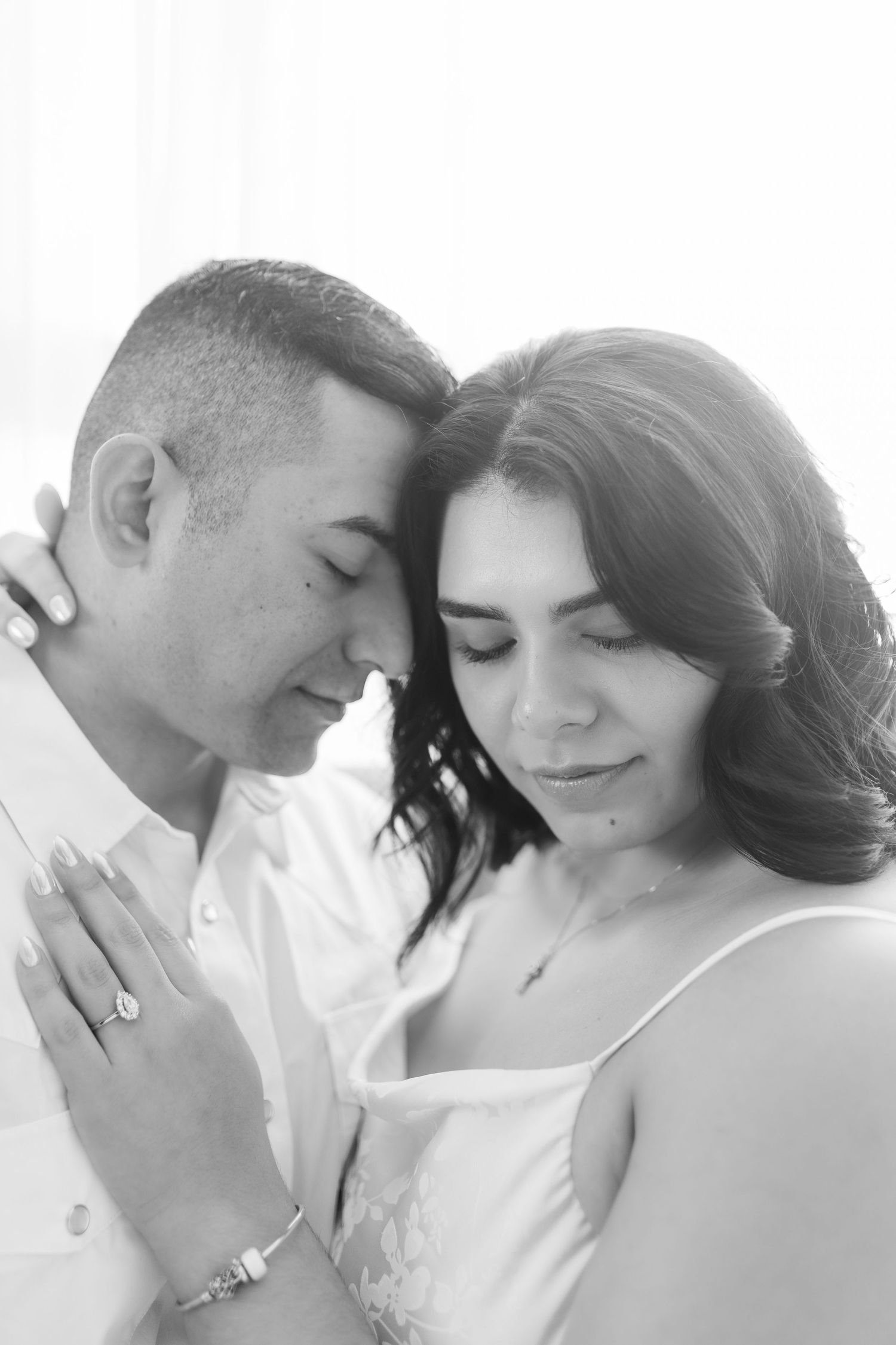 Black and white wedding photo collage showing three intimate romantic moments between a couple.