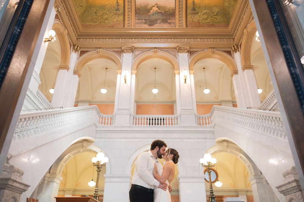 A romantic photoshoot in a grand historic building with classical architecture and ornate details.