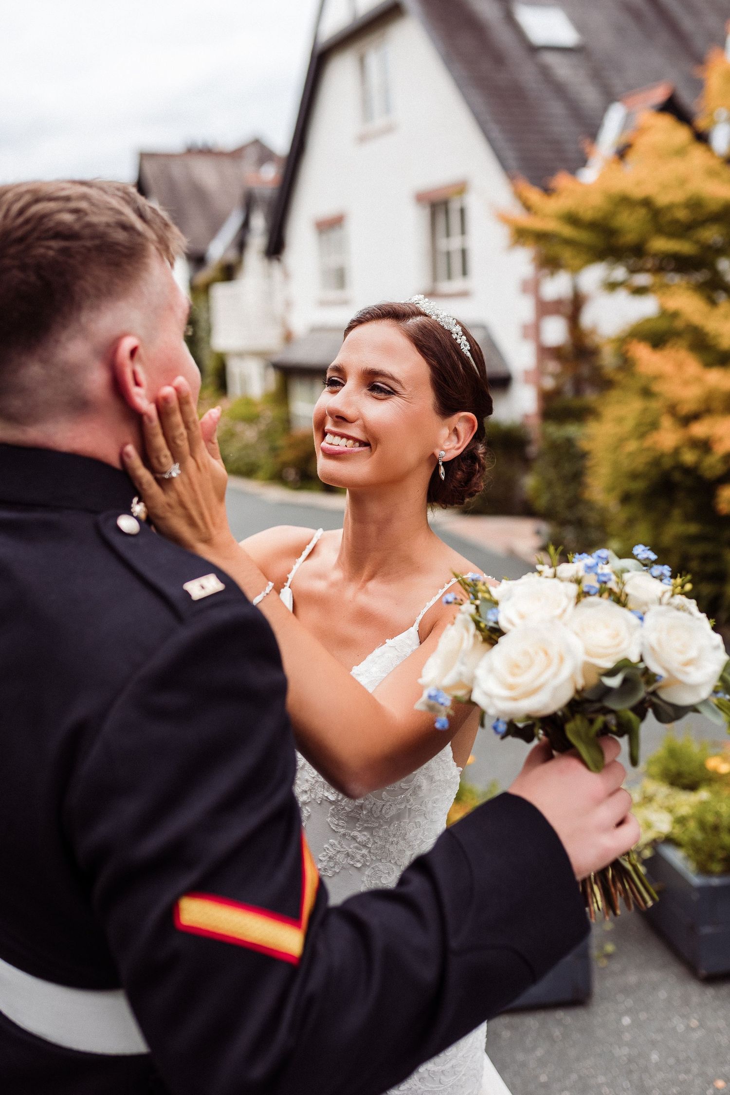 A happy couple shares a joyful moment during their wedding celebration outdoors.