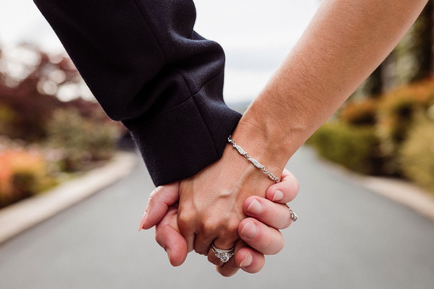 Close-up view of hands holding each other during a formal ceremony.