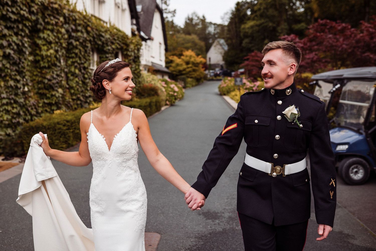A couple shares a romantic moment together on a tree-lined path during their wedding celebration.
