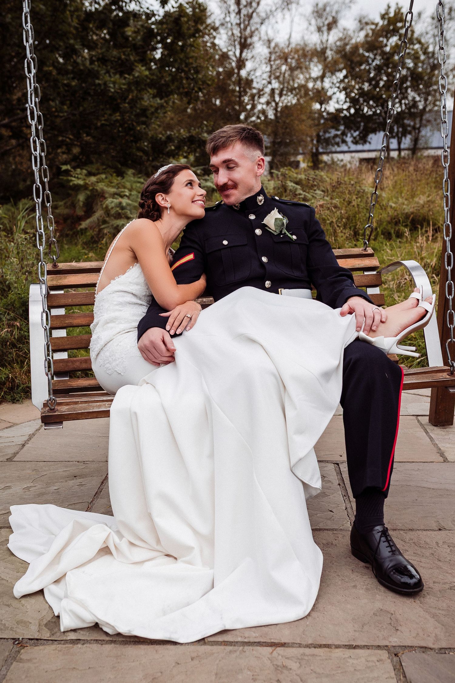 A newlywed couple sits together on a wooden bench in a romantic sequence of candid wedding photos.