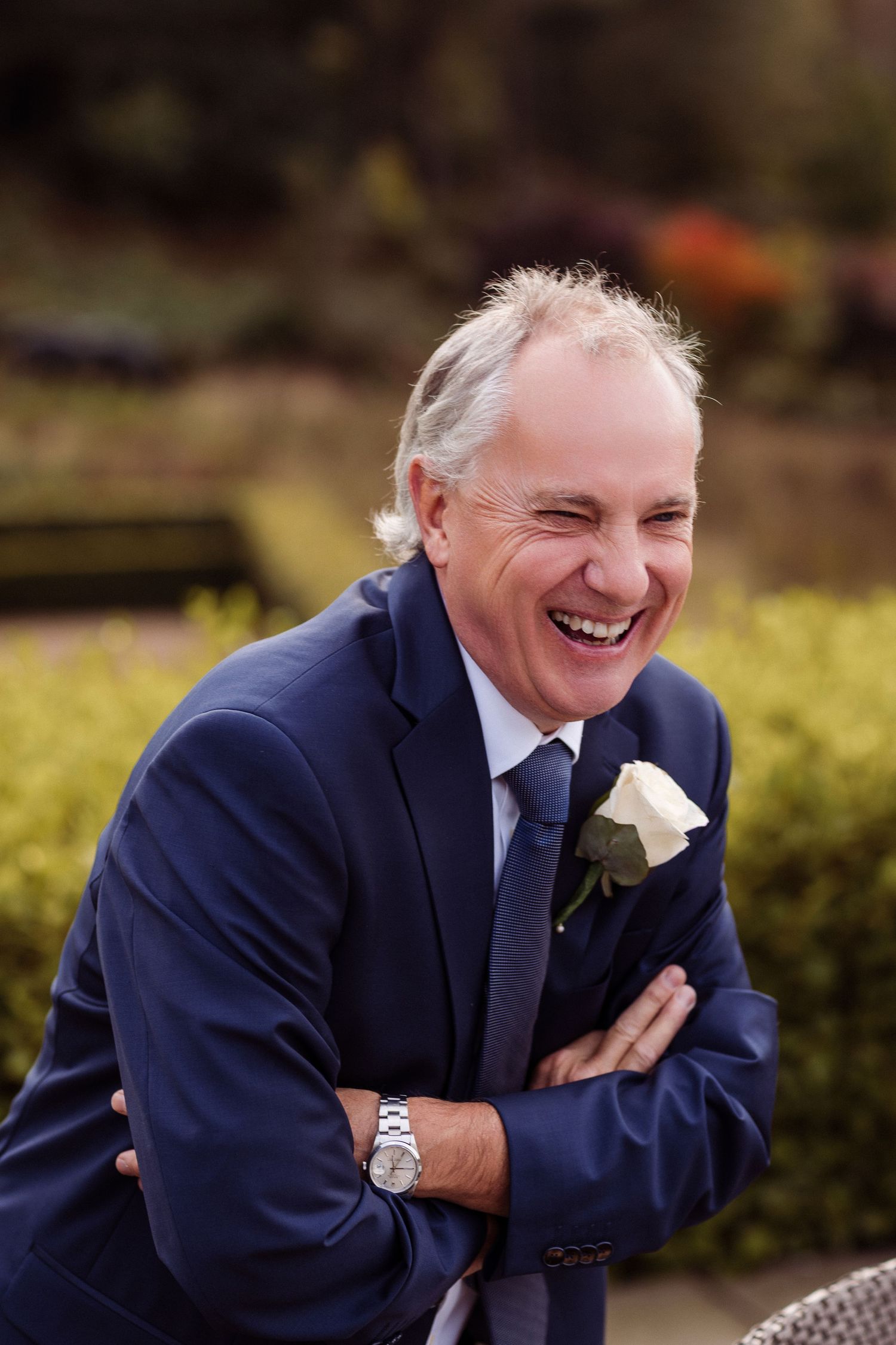 A sequence of photos shows someone in a navy suit displaying increasingly joyful expressions outdoors.