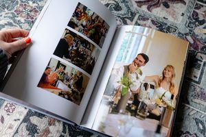 A collection of photo album pages spread out showing wedding and family memories in printed photographs.
