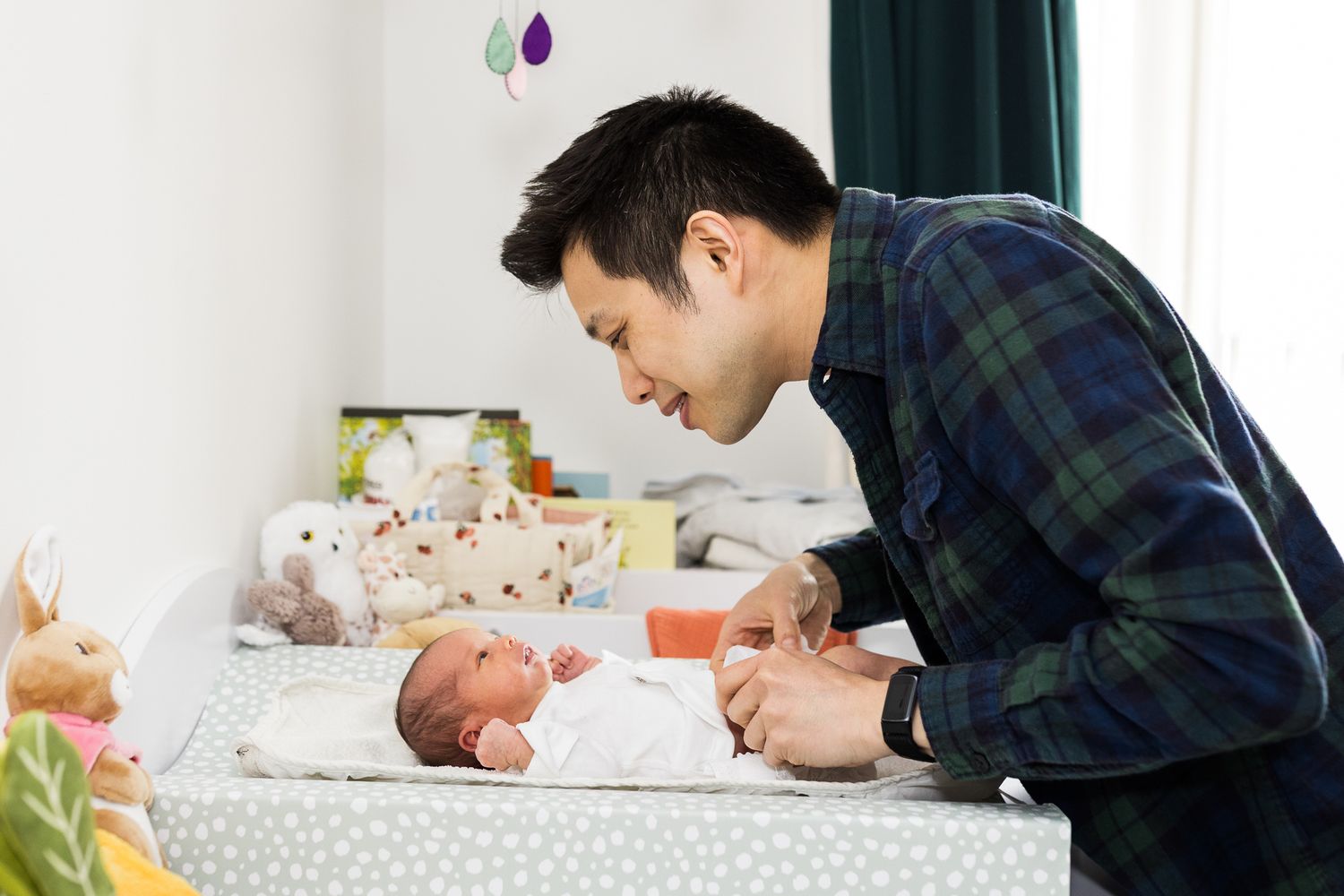 dad changing baby girl clothes