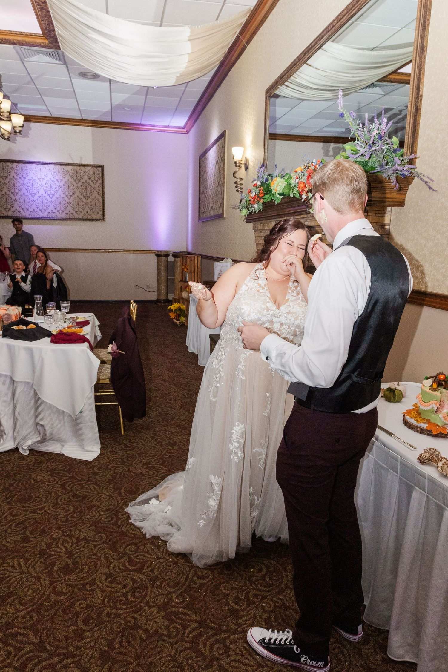Couple shares first dance in elegantly decorated reception hall.