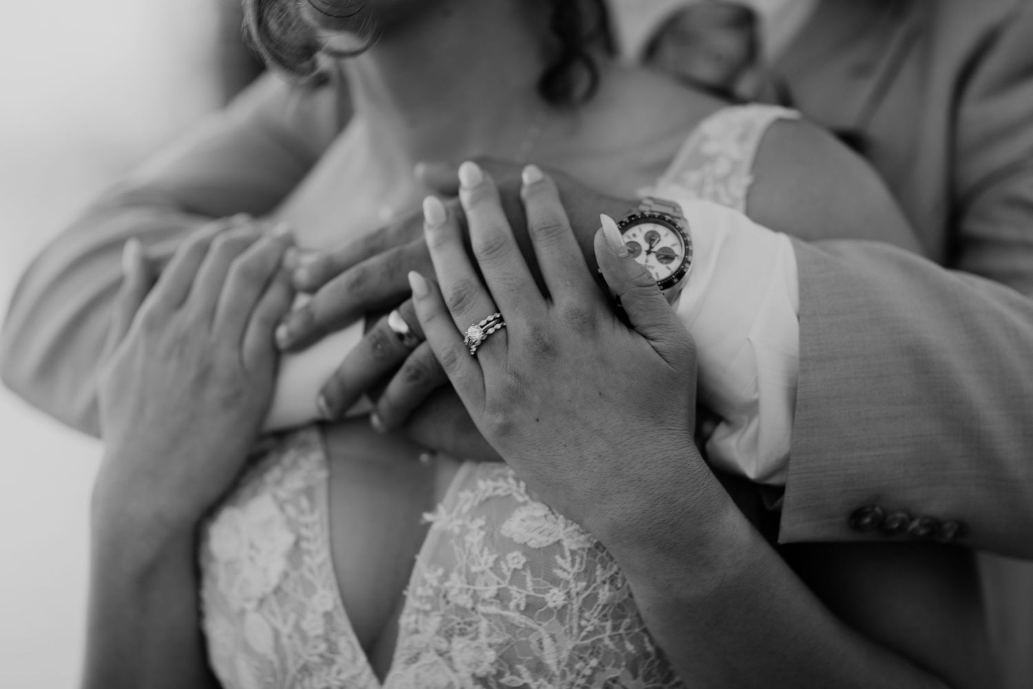 Black and white close-up of emotional wedding moment.