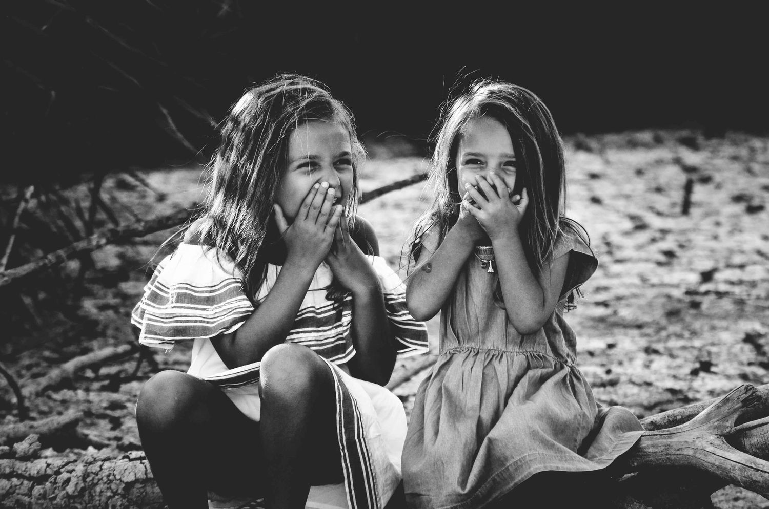 Sisters giggle during a portrait session