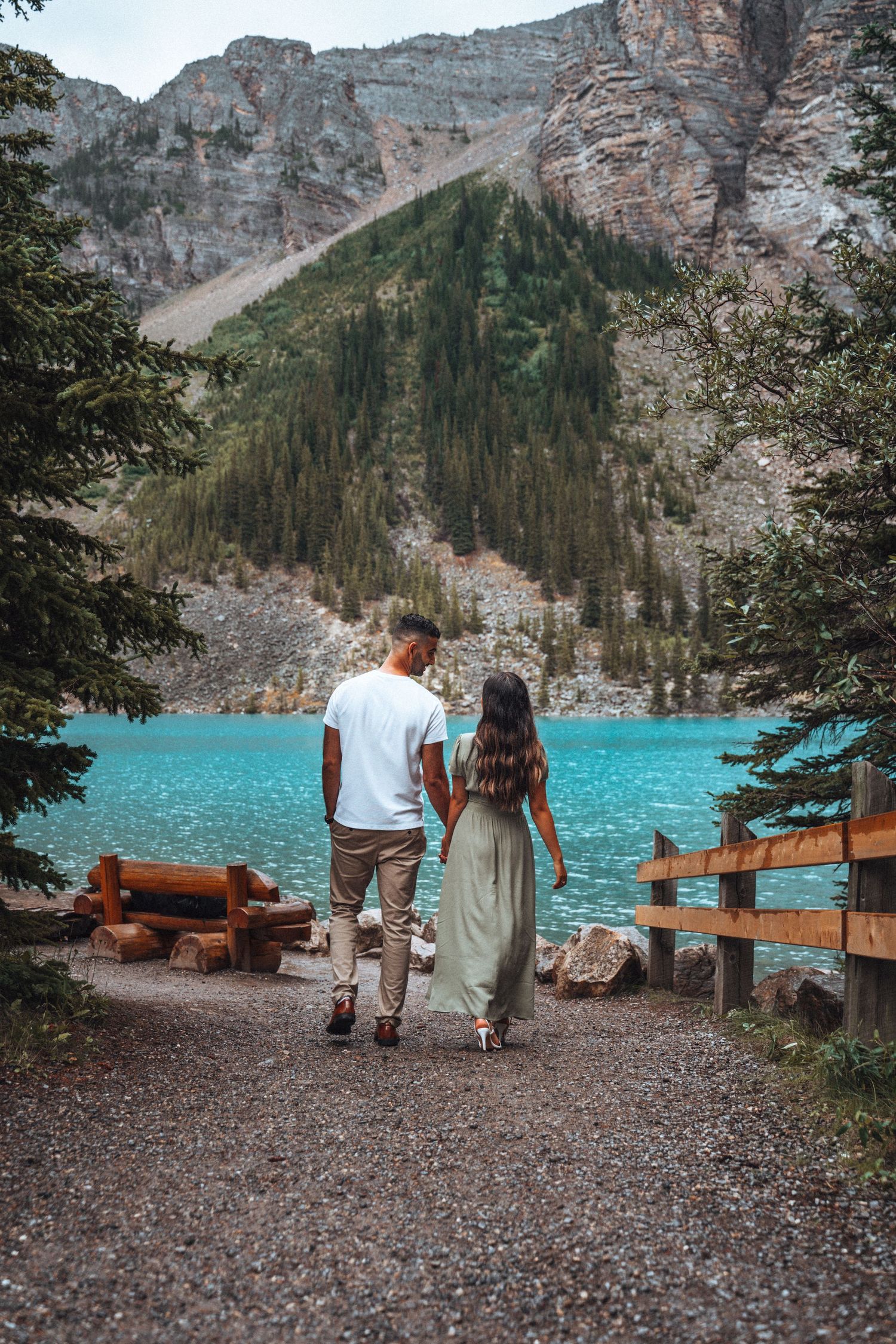 Couple strolling by Moraine Lake. Banff engagement photography.