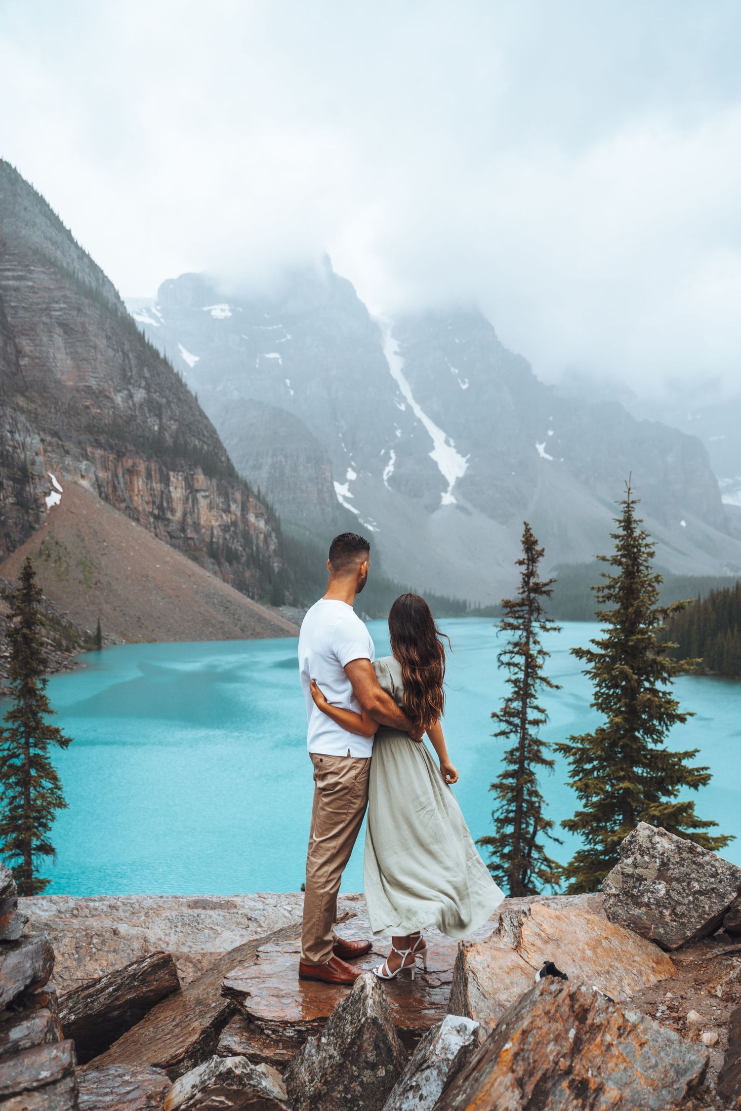 Couple looking at Moraine Lake. Banff engagement photography.