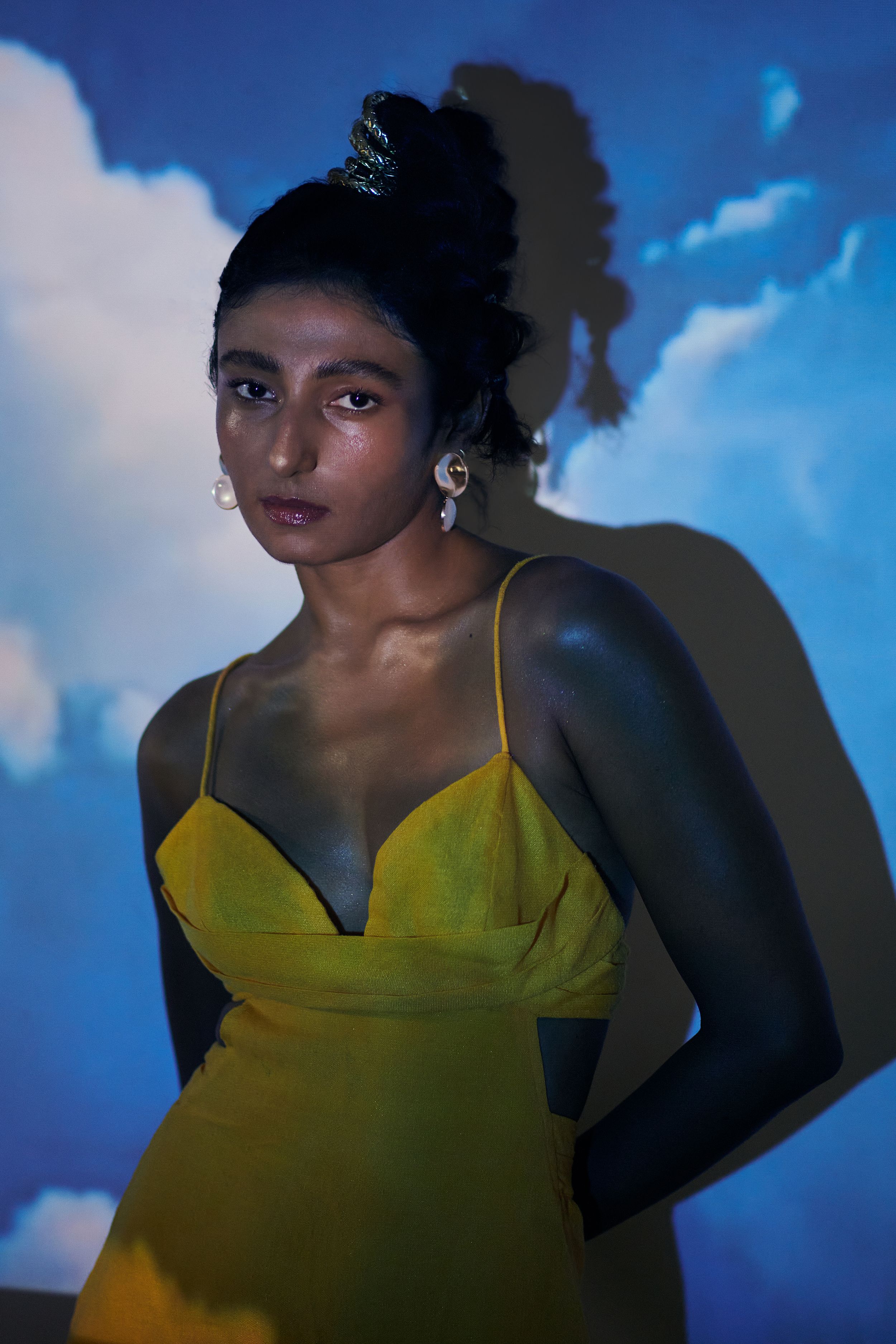 model posing standing behind projector