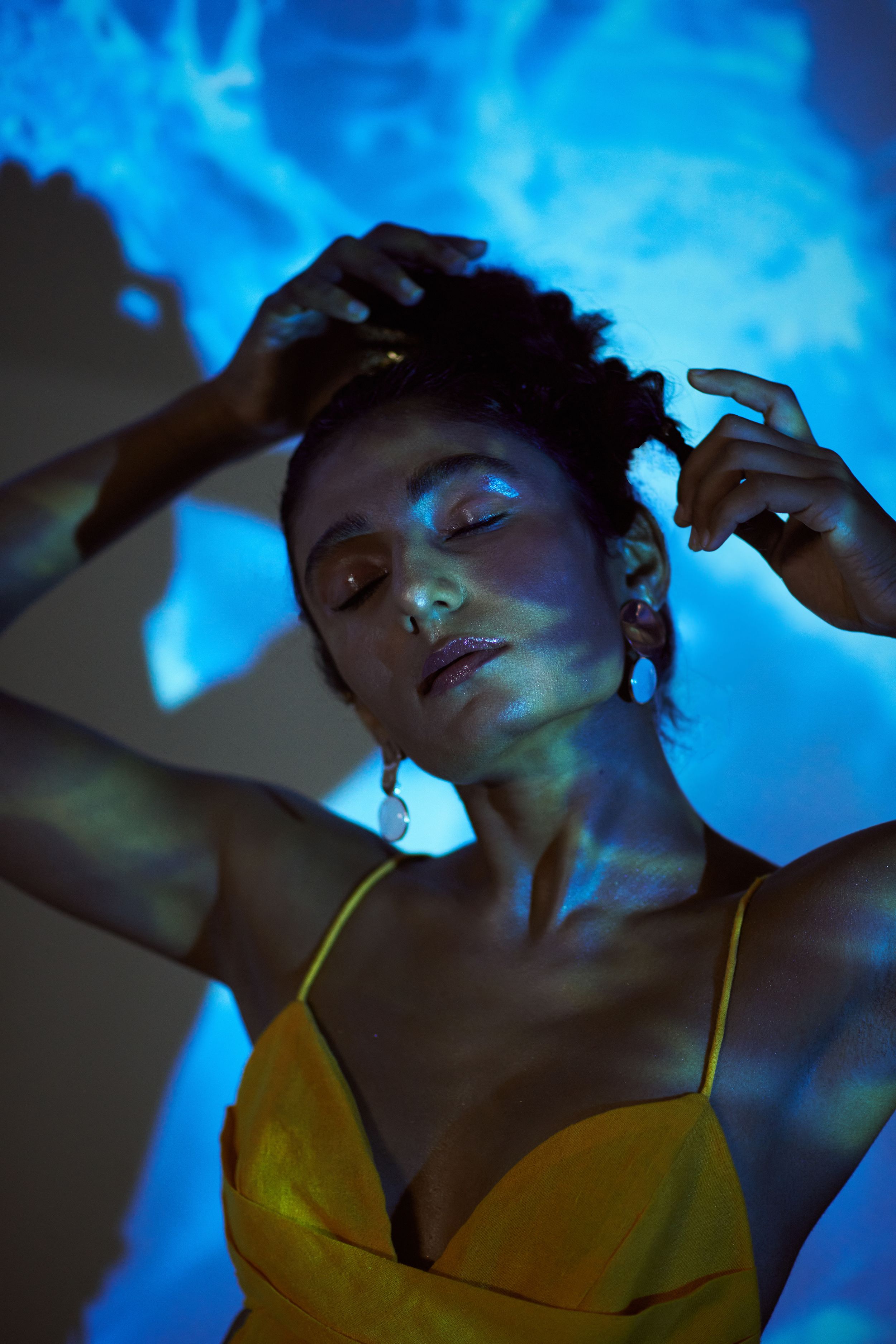 model posing standing behind projector