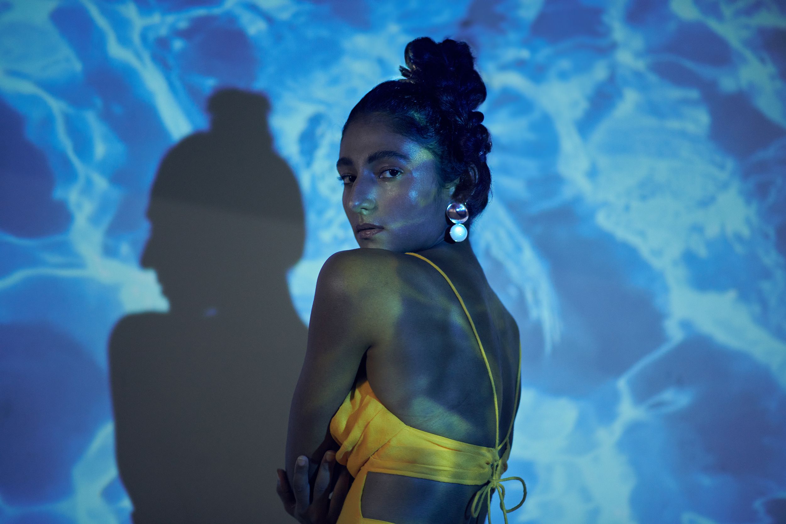 model posing standing behind projector