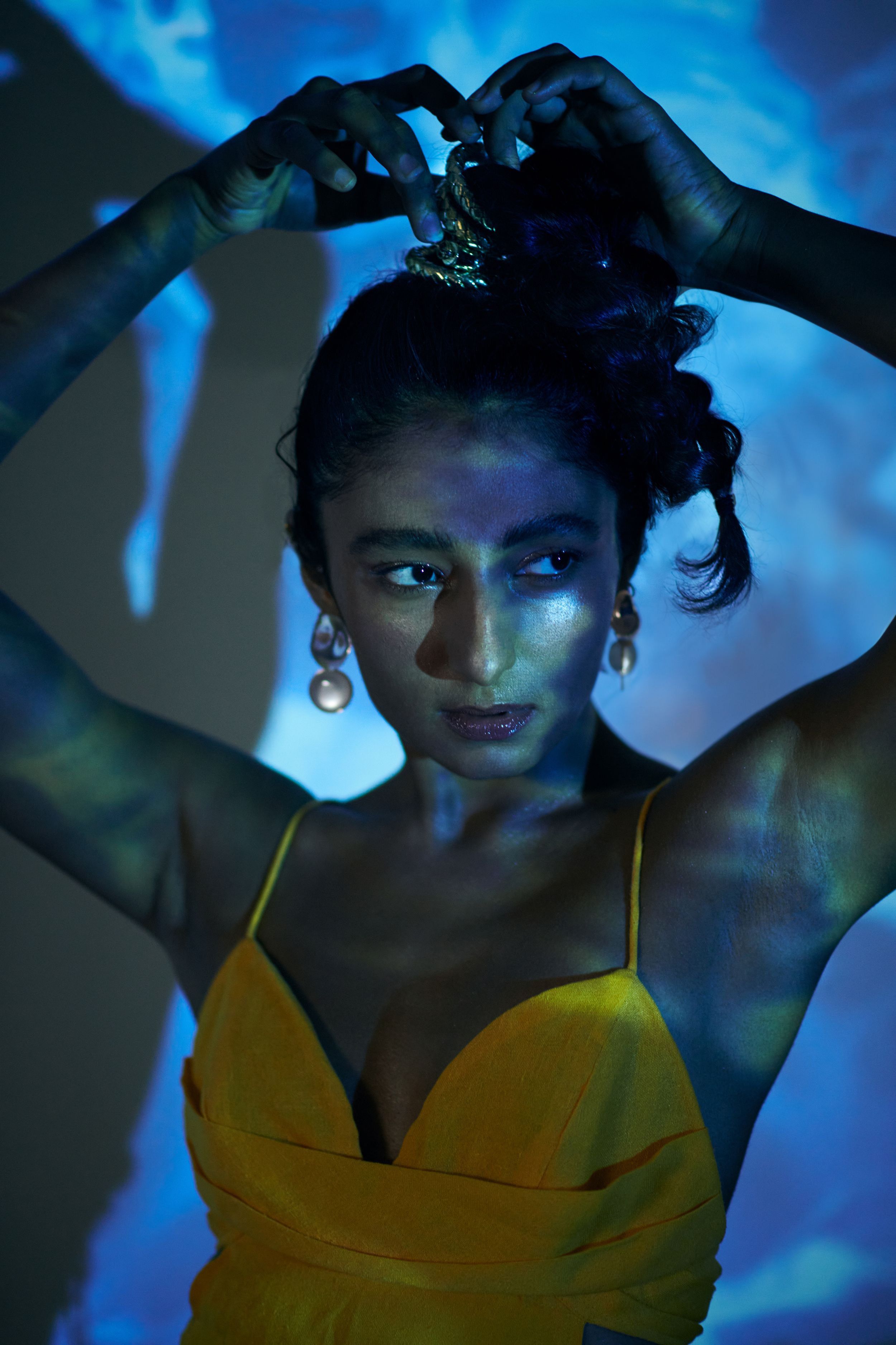 model posing standing behind projector