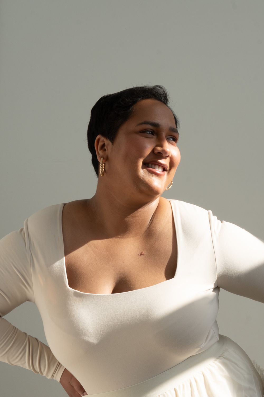 A series of artistic portrait photos against a white background showing close-up details in dramatic shadow and light.