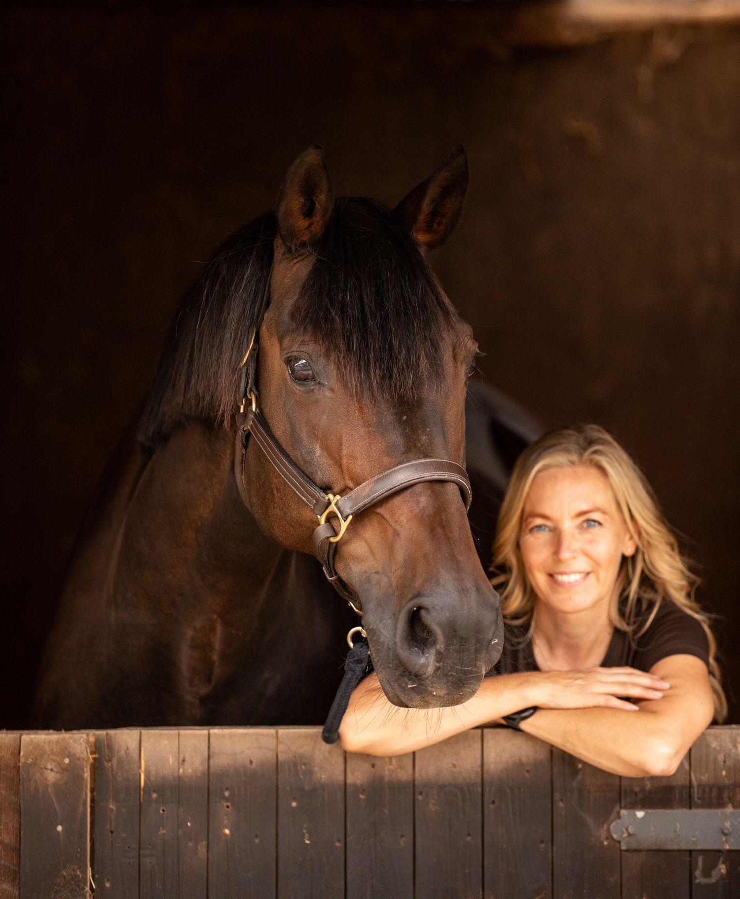 Young equestrian poses with palomino pony in a series of natural outdoor portraits showing their special bond.