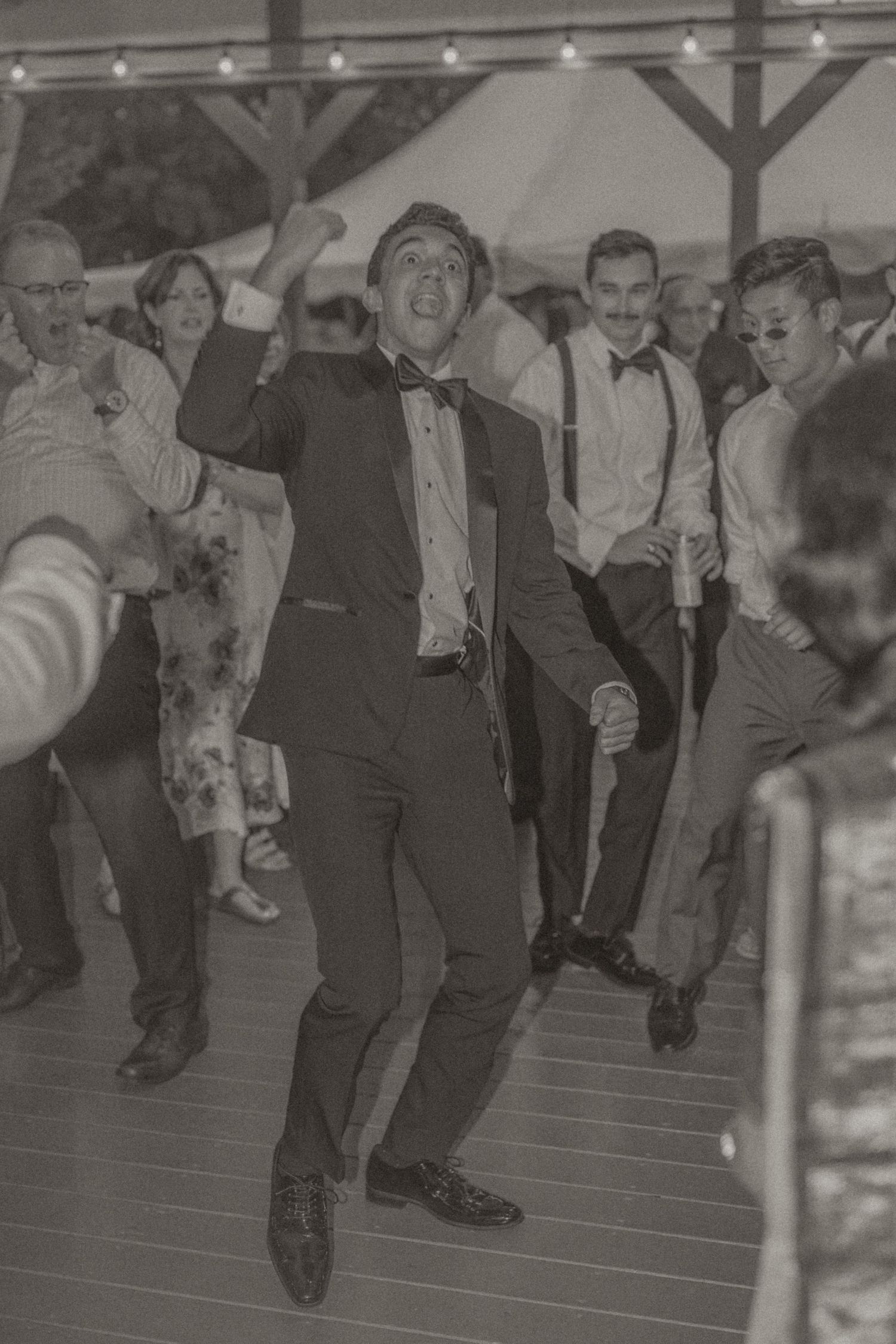Guests dancing and celebrating at Gaie Lea, Staunton, VA, with bride and groom sharing intimate moments, candid style.